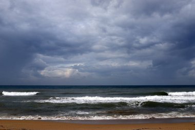 Rain clouds in the sky over the Mediterranean Sea. 