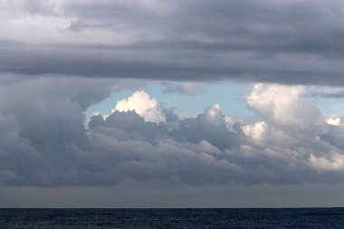 Rain clouds in the sky over the Mediterranean Sea. 