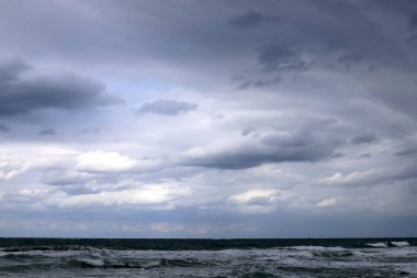 Rain clouds in the sky over the Mediterranean Sea. 