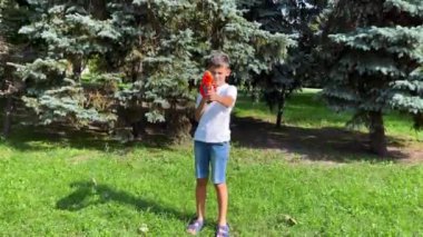 A boy playing with his nerf gun at the park. 