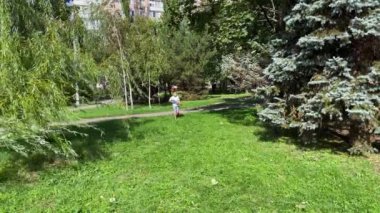 A boy playing with his nerf gun at the park. 