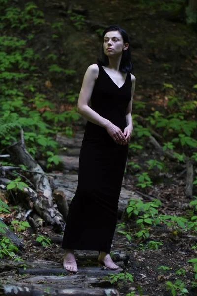 一个穿着雅致衣服的漂亮姑娘在森林里摆姿势 — 图库照片