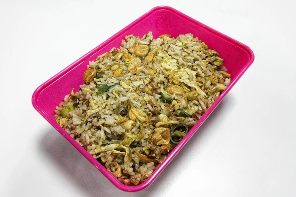 Fried rice in purple food container on white background. Anchovy fried rice in purple box with white background. Right side view.