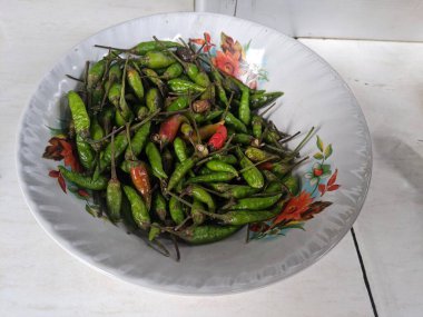 Withered green chilies in a bowl, dry green chili in a bowl.