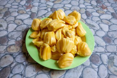 Fresh yellow jackfruit, fresh yellow jackfruit on a green plate.