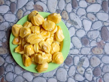 Fresh yellow jackfruit, fresh yellow jackfruit on a green plate.