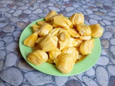 Fresh yellow jackfruit, fresh yellow jackfruit on a green plate.