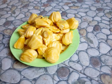 Fresh yellow jackfruit, fresh yellow jackfruit on a green plate.