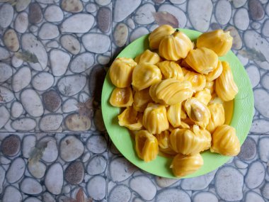 Fresh yellow jackfruit, fresh yellow jackfruit on a green plate.