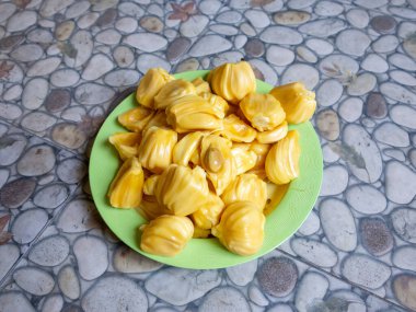 Fresh yellow jackfruit, fresh yellow jackfruit on a green plate.