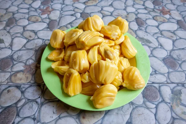 Fresh yellow jackfruit, fresh yellow jackfruit on a green plate.