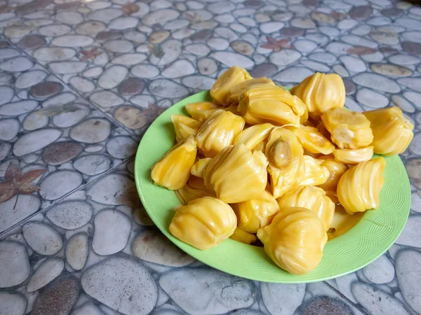 Fresh yellow jackfruit, fresh yellow jackfruit on a green plate.