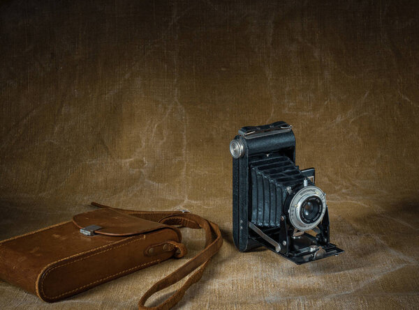 Old film camera Kodak Brownie with a case shot in retro style.