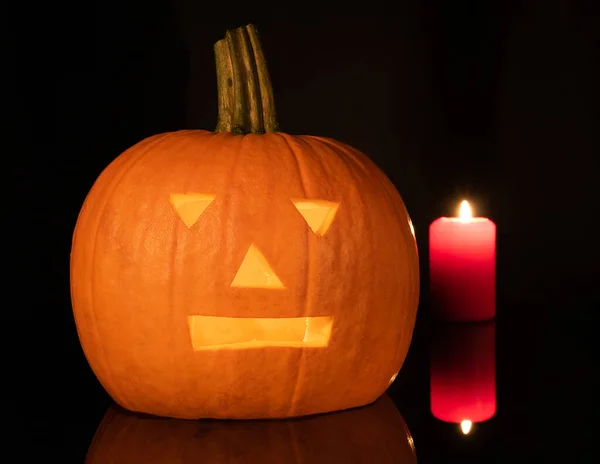 Scary pumpkin mask with candles burning inside.