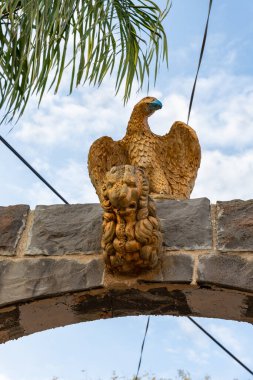 Bir kartal ve bir aslanın yaldızlı figürleri İslami Çerkez 'in kuzey İsrail' deki Celile 'deki Nasıra' ya yakın Kfar Kama adlı Müslüman köyünün kapısının üzerinde.