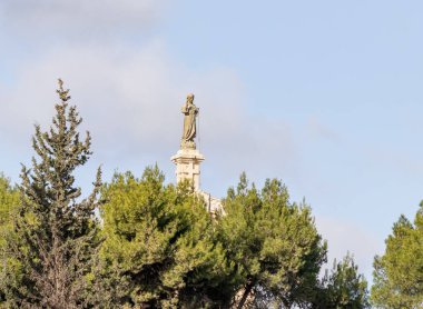 Bethlehem, Israel, December 25, 2021 : Stone statue of the Virgin Mary standing on the roof of a building in Bethlehem in the Palestinian Authority, Israel