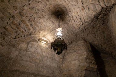 Bethlehem, Israel, December 25, 2021 : The lamp hangs from the ceiling in the underground hall of the wall of the Church of Nativity in Bethlehem in the Palestinian Authority, Israel