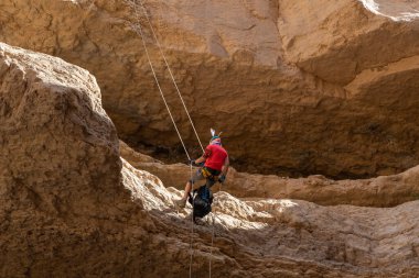 Kudüs, İsrail, 05 Mayıs 2022: İsrail Bağımsızlık Günü deneyimli sporcusu, İsrail 'in Kudüs kenti yakınlarındaki Khatsatson deresi yakınlarındaki Judean Çölü dağlarında iple iple iniyor..