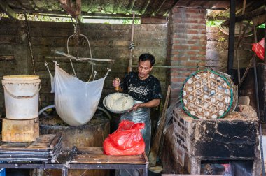 Bali, Indonesia, July, 2022.  Local workers make tofu from soybeans. Process of making tofu