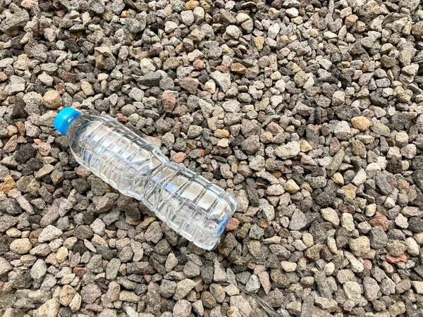 mineral water bottle on rocks background. thirst refresher after outdoor activity