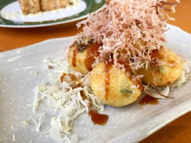 Japanese snack, takoyaki ball. Takoyaki is a flour based snack in the shape of little round balls containing pieces of octopus.