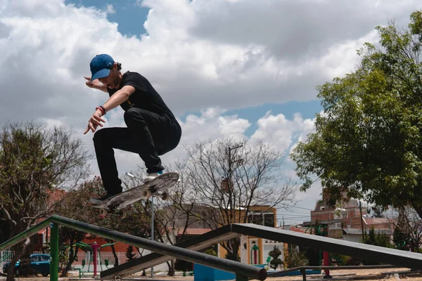 Skater Dressed Black Wearing Cap Air While Falling His Skateboard — 图库照片