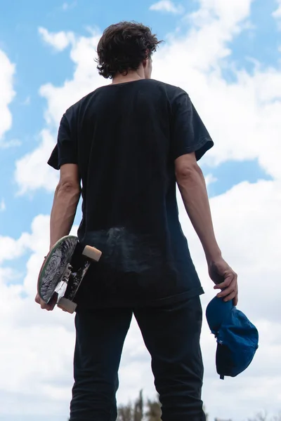 Skater Wearing Black Shirt Holding His Board Cap Blue Sky 图库图片