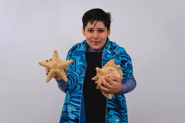 Boy White Background Bathing Suit Towel Seashell Starfish His Hand — стоковое фото