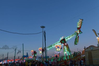 Fair attractions with led lights in blue hour