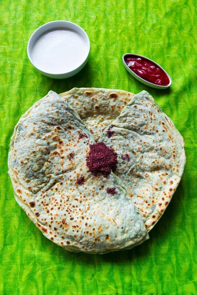 Azerbaijani national cuisine dish called Kutab with greens with sumac and yogurt