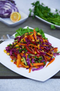 Vegetable salad of red cabbage carrots corn dressed with lemon juice
