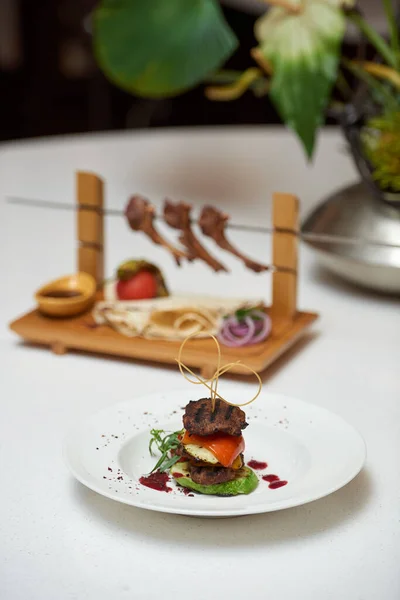Azerbaijani shish kebab lamb ribs on a skewer with garnish and lavash from the chef