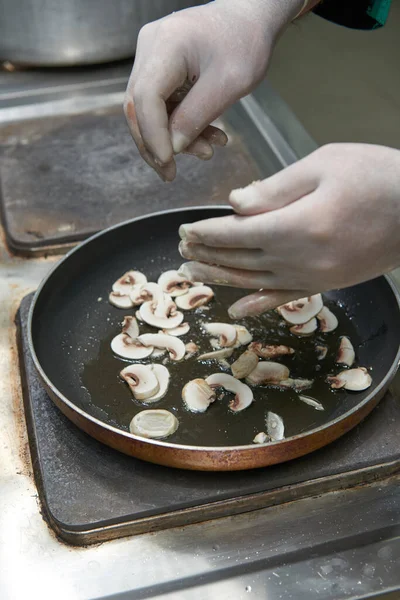 Roasting mushrooms in a boiling pan with cream professional chef