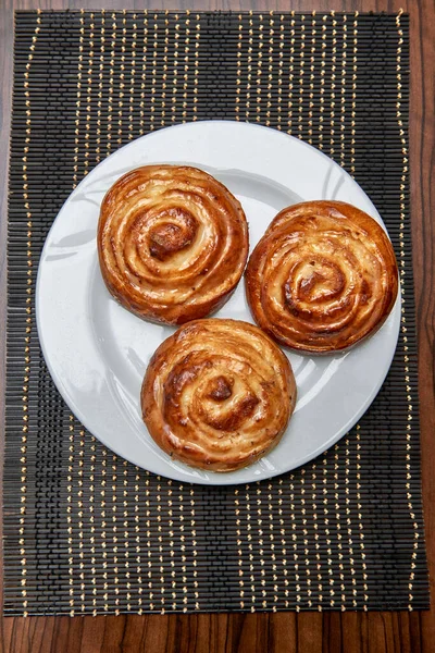 Puff buns with caramel filling on a plate studio shooting