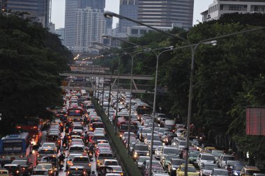 Evening time in Thailand Bangkok traffic an incredible number of cars you can stand in traffic jams for hours the best way to travel on motorcycles