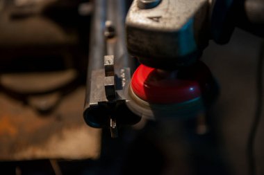 Baku Azerbaijan weapons workshop grinding by a grinder preparing a gun barrel for burnishing