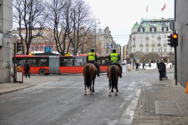 Norway city of Oslo in winter city center frost snow streets police officers trolling on horseback keeping order