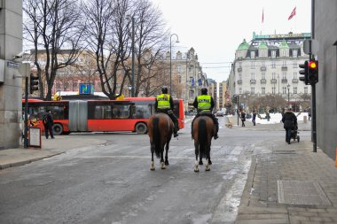 Norway city of Oslo in winter city center frost snow streets police officers trolling on horseback keeping order