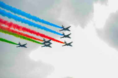 A fighter jet in the sky over the city of Baku shows the highest aerobatics of the tricolor flag of Azerbaijan clipart