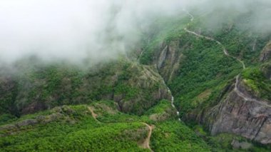 Clouds over beautiful summer mountains green forest, magical natural morning fog nature background 4k landscape