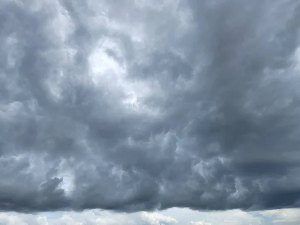 cloudy sky with black clouds forming a straight line