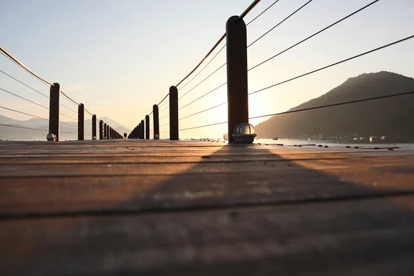 Wooded bridge in the port between sunrise at Ubatuba, Brazil. High quality photo