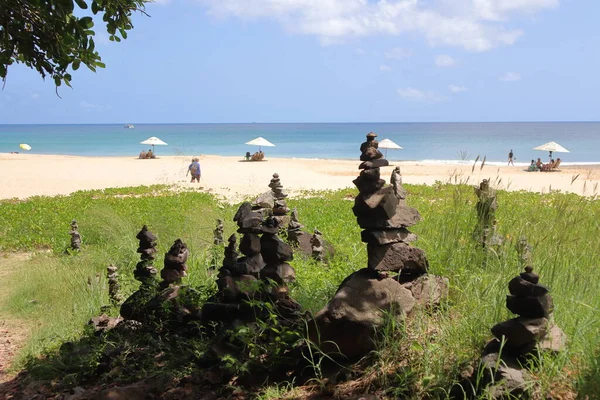 Rock cairn at trail to Bode beach at Fernando de Noronha island, Brazil.. Sunny august day. Forest.