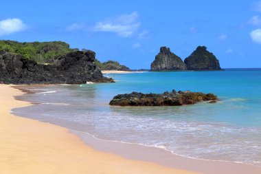 Cacimba do padre beach against two brothers hills on the background, at Fernando de Noronha, Pernambuco, Brazil, in a sunny winter day. High quality photo