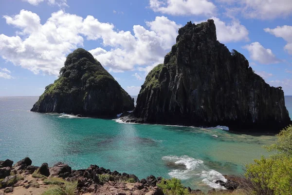 View of Two Brothers Mountain - Morro dos Dois Irmaos in Portuguese- from from the top of a neighboring hill in Fernando de Noronha, Brazil. High quality photo