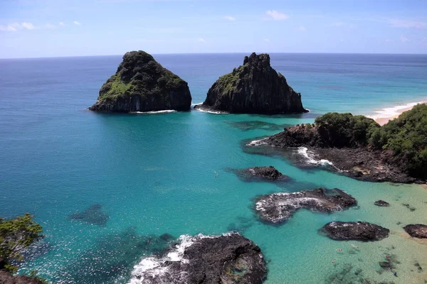 View of Two Brothers Mountain - Morro dos Dois Irmaos in Portuguese- from from the top of a neighboring hill in Fernando de Noronha, Brazil. High quality photo