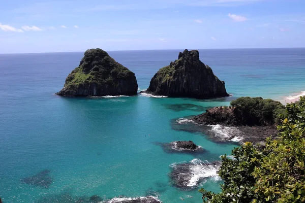 View of Two Brothers Mountain - Morro dos Dois Irmaos in Portuguese- from from the top of a neighboring hill in Fernando de Noronha, Brazil. High quality photo