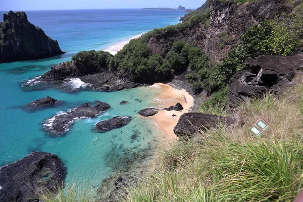 View towards the vertical rock cliffs of Baia dos Porcos, Pigs Bay, on the remote island paradise of Fernando de Noronha off the coast of Pernambuco, Brazil. . High quality photo