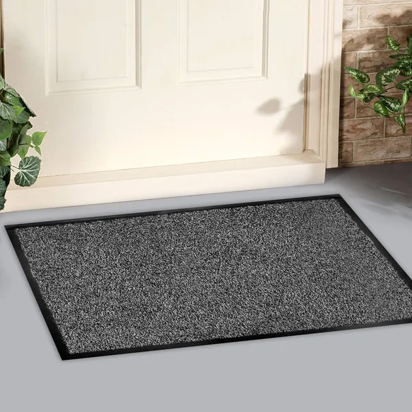 Classic black grey welcome door mat with black border outside home with yellow flowers and leaves