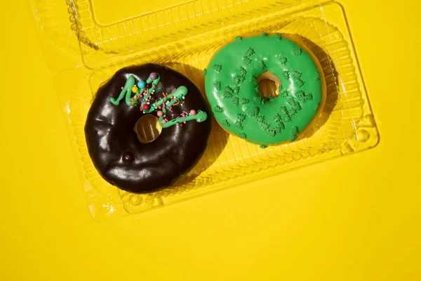 Horizontal photo of two donuts in a box. Studio photo.